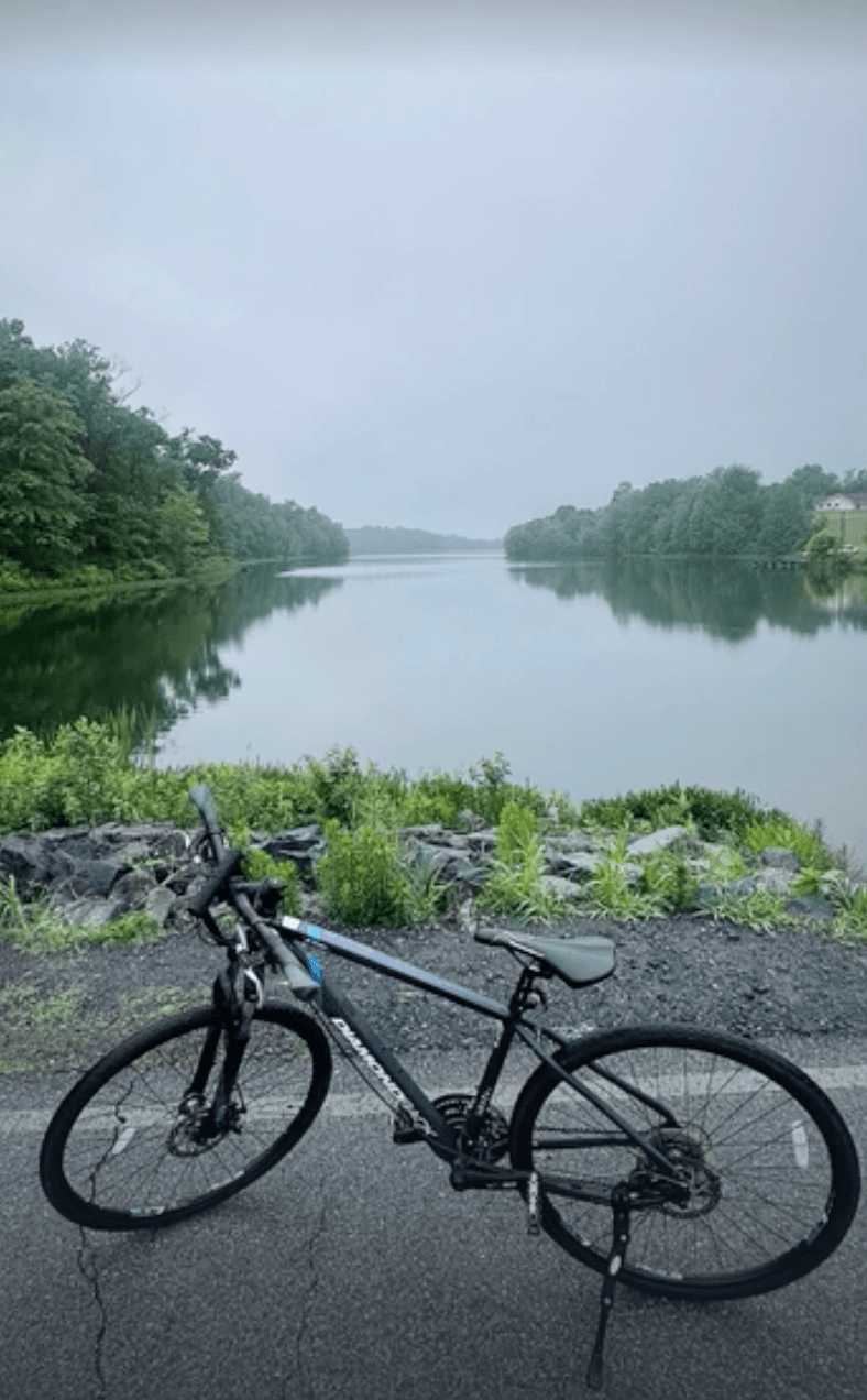 A bike parked by a lake during a long ride