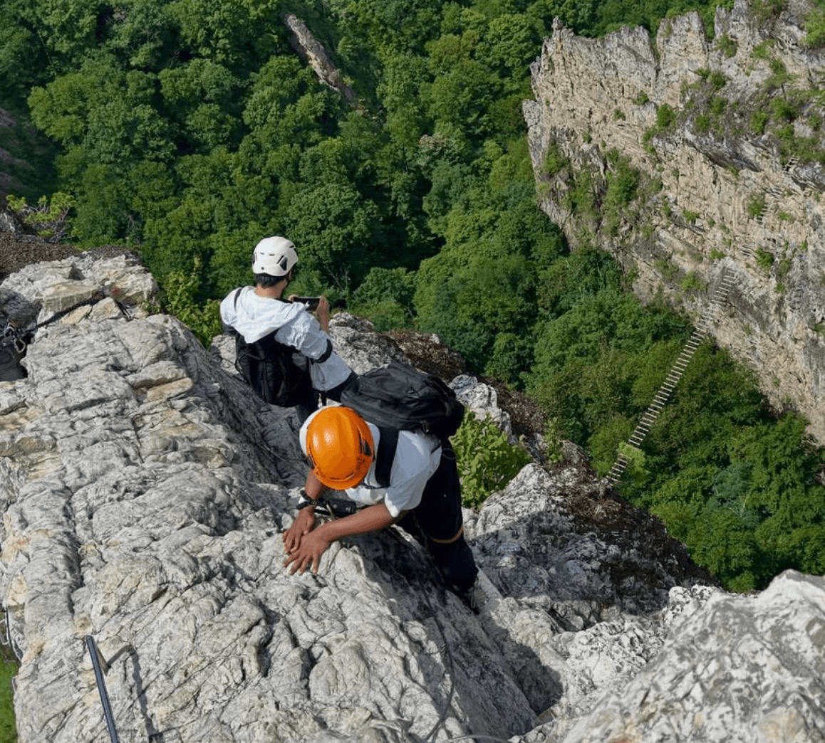 Ritviik climbing on a rocky outdoor route